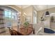 Elegant dining area with a wood table, chandelier, and bird artwork at 872 Clear Lake Dr, Englewood, FL 34223