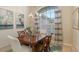 Bright dining room with wood table, bird artwork, and window seating at 872 Clear Lake Dr, Englewood, FL 34223