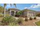 Well-maintained house with lush landscaping and a two-car garage at 872 Clear Lake Dr, Englewood, FL 34223