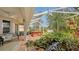 Enclosed patio features a hot tub and a tranquil water feature at 872 Clear Lake Dr, Englewood, FL 34223
