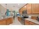 Spacious kitchen with an island, granite countertops and stainless steel appliances at 872 Clear Lake Dr, Englewood, FL 34223