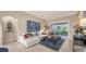 Relaxing living space with a sectional sofa, coffee table, and access to patio at 872 Clear Lake Dr, Englewood, FL 34223