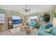 Bright living room with comfy sofas, a large TV, and access to a patio at 872 Clear Lake Dr, Englewood, FL 34223