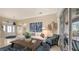 Open living room with sectional sofa, coffee table, and views to the front entry and lanai at 872 Clear Lake Dr, Englewood, FL 34223