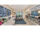 Spacious living area with sectional sofa, large artwork, and view of kitchen at 872 Clear Lake Dr, Englewood, FL 34223