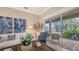 Living area with comfortable seating, large windows, and access to a patio with water views at 872 Clear Lake Dr, Englewood, FL 34223