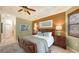 Bright main bedroom with a king-size bed and large windows at 872 Clear Lake Dr, Englewood, FL 34223