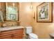 Stylish powder room with granite vanity and unique artwork at 8808 Enclave Ct, Sarasota, FL 34238