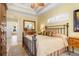 Spacious bedroom with a metal bed frame and ensuite bathroom access at 8808 Enclave Ct, Sarasota, FL 34238