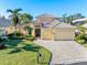 Beautiful two-story home with tile roof, three car garage, and landscaped yard at 8808 Enclave Ct, Sarasota, FL 34238