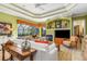 Living Room with fireplace and view of the pool and lanai at 8808 Enclave Ct, Sarasota, FL 34238