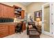 Bright office with built-in wood cabinets and a comfortable chair at 8808 Enclave Ct, Sarasota, FL 34238
