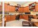 Home office with built-in wood cabinets and a leather chair at 8808 Enclave Ct, Sarasota, FL 34238