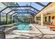 Inviting pool and spa with covered patio; outdoor kitchen and seating at 8808 Enclave Ct, Sarasota, FL 34238
