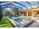 Spacious pool and spa area with screened enclosure and lounge chairs at 8808 Enclave Ct, Sarasota, FL 34238
