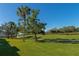 Landscaped walkway with palm trees and lush grass at 9480 High Gate Dr # 2111, Sarasota, FL 34238