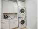 Laundry room with stacked washer and dryer, and cabinets at 103 Graham Se St, Port Charlotte, FL 33952