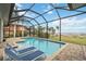 Enclosed pool with lounge chairs and water view at 103 Graham Se St, Port Charlotte, FL 33952