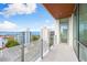 Spacious balcony with water views and modern glass railing at 111 Golden Gate Pt # 701Ph, Sarasota, FL 34236