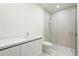 Modern bathroom with a walk-in shower and white cabinetry at 111 Golden Gate Pt # 701Ph, Sarasota, FL 34236