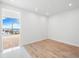 Bright bedroom with hardwood floors and access to balcony with water views at 111 Golden Gate Pt # 701Ph, Sarasota, FL 34236