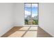 Bedroom with hardwood floors and large window with city view at 111 Golden Gate Pt # 701Ph, Sarasota, FL 34236