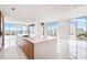 Contemporary kitchen featuring large island and water views at 111 Golden Gate Pt # 701Ph, Sarasota, FL 34236