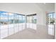 Bright living room with expansive windows and water views at 111 Golden Gate Pt # 701Ph, Sarasota, FL 34236