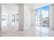 Open living area with water and city views from large windows at 111 Golden Gate Pt # 701Ph, Sarasota, FL 34236