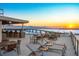 Stunning rooftop terrace with city views, seating areas, and sunset views at 111 Golden Gate Pt # 701Ph, Sarasota, FL 34236