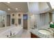 Spa-like bathroom with granite vanity, large soaking tub, and walk-in shower at 1225 S View Dr, Sarasota, FL 34242