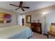 Bedroom with large sunflower painting and dresser at 1225 S View Dr, Sarasota, FL 34242