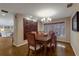 Bright dining room features a large wood table with six chairs and hardwood floors at 1225 S View Dr, Sarasota, FL 34242