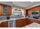 Kitchen features granite countertops, stainless steel appliances, and wood cabinets at 1225 S View Dr, Sarasota, FL 34242