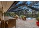 Relaxing screened pool area with patio furniture and dining table at 1225 S View Dr, Sarasota, FL 34242