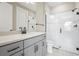 Modern bathroom boasts a large shower, gray vanity, and white subway tile at 12409 Wigeon Dr, Bradenton, FL 34212