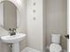 Small bathroom with pedestal sink and circular mirror at 12409 Wigeon Dr, Bradenton, FL 34212