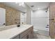 Modern bathroom with a bathtub, vanity, and unique patterned wallpaper at 12409 Wigeon Dr, Bradenton, FL 34212