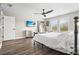 Main bedroom with wood-look floors, ceiling fan and large mirror at 12409 Wigeon Dr, Bradenton, FL 34212