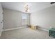 Bright bedroom with carpet flooring, window with shutters, and stylish light fixture at 12409 Wigeon Dr, Bradenton, FL 34212