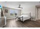 Main bedroom with wood-look floors, ceiling fan and plenty of natural light at 12409 Wigeon Dr, Bradenton, FL 34212