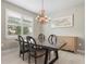 Bright dining room with wood table and pineapple chandelier at 12409 Wigeon Dr, Bradenton, FL 34212