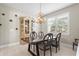 Dining room features a rustic wood table and statement chandelier at 12409 Wigeon Dr, Bradenton, FL 34212