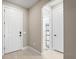 Bright entryway with white door and view to another room at 12409 Wigeon Dr, Bradenton, FL 34212