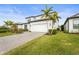 Two-story house with white garage door, palm trees, and brick driveway at 12409 Wigeon Dr, Bradenton, FL 34212