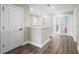 Upstairs hallway with wood-look floors and access to bedrooms and laundry at 12409 Wigeon Dr, Bradenton, FL 34212