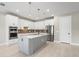 Modern kitchen with white cabinets, gray island, and stainless steel appliances at 12409 Wigeon Dr, Bradenton, FL 34212