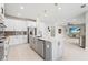 Modern kitchen with white cabinets, gray island, and stainless steel appliances at 12409 Wigeon Dr, Bradenton, FL 34212