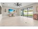 Spacious living room with tile floors, TV, and sliding glass doors at 12409 Wigeon Dr, Bradenton, FL 34212