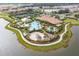 Aerial view of community pool, tennis courts, and clubhouse at 12410 Osorio Ct # 103, Sarasota, FL 34238